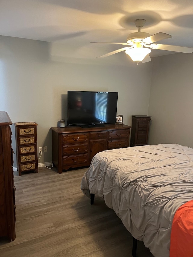 bedroom with ceiling fan and hardwood / wood-style floors