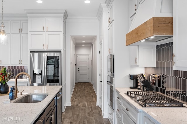 kitchen with custom exhaust hood, stainless steel appliances, sink, dark wood-type flooring, and white cabinets