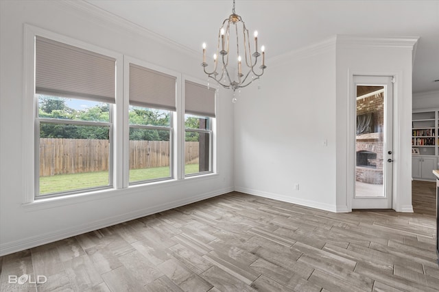 spare room featuring ornamental molding, an inviting chandelier, and light hardwood / wood-style floors