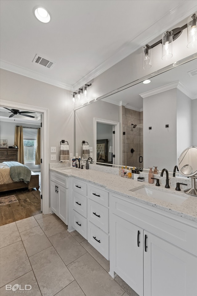 bathroom with vanity, hardwood / wood-style flooring, crown molding, and a shower with shower door