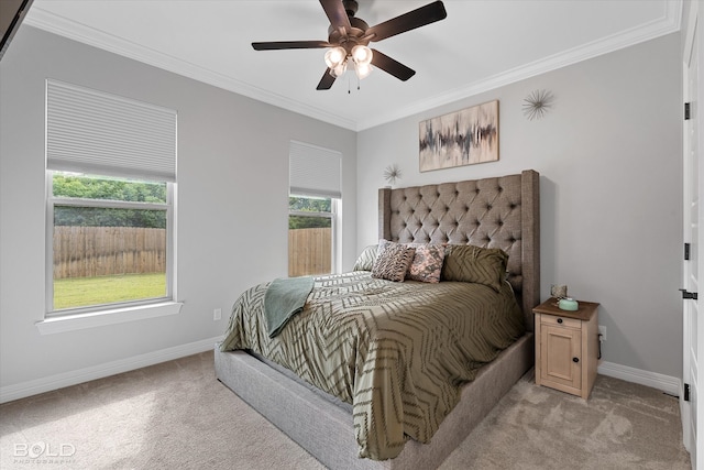 carpeted bedroom featuring ornamental molding and ceiling fan