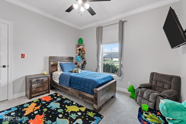 carpeted bedroom with ceiling fan and ornamental molding