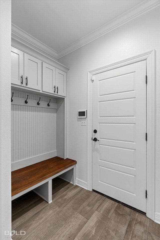 mudroom with crown molding and light hardwood / wood-style flooring