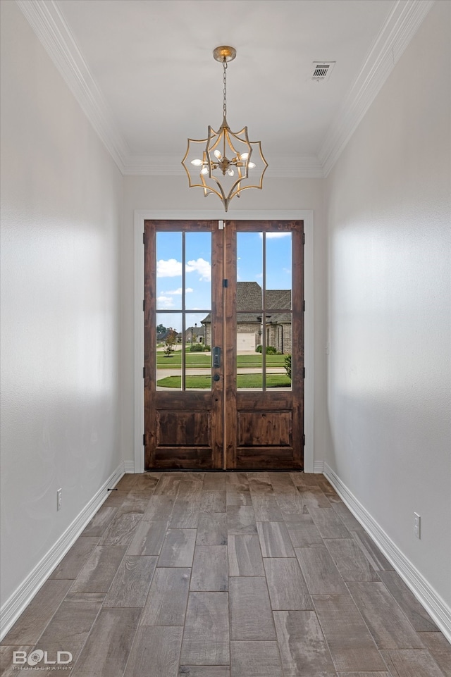 interior space featuring crown molding, a notable chandelier, and french doors