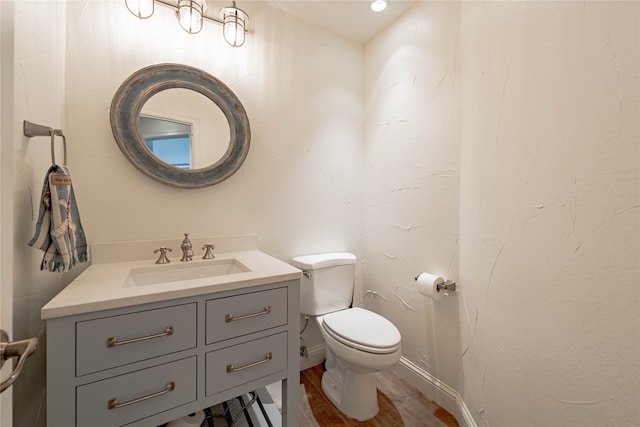 bathroom featuring hardwood / wood-style floors, toilet, and vanity