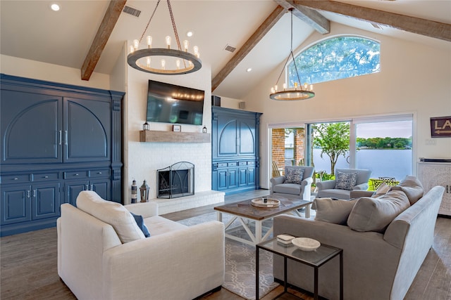 living room with an inviting chandelier, a brick fireplace, wood-type flooring, high vaulted ceiling, and beam ceiling