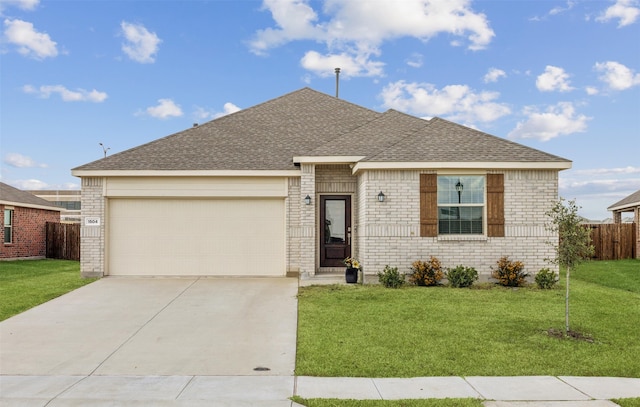 single story home featuring a garage and a front lawn