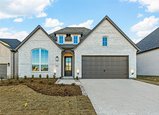 french country style house with a garage