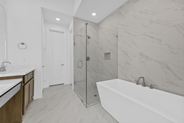 bathroom featuring vanity and independent shower and bath