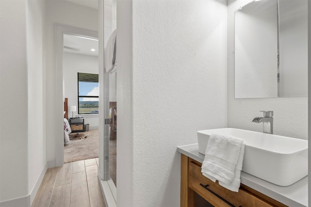 bathroom with vanity and wood-type flooring