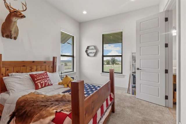 bedroom featuring light colored carpet