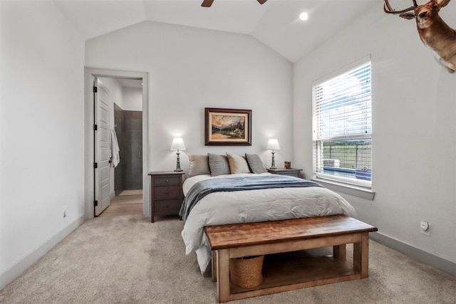 bedroom featuring ceiling fan, vaulted ceiling, and light colored carpet