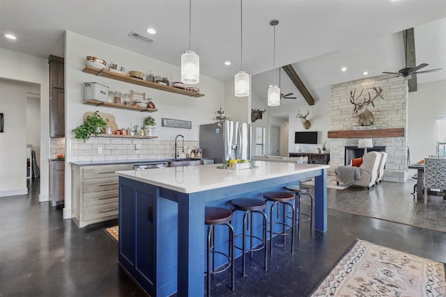 kitchen featuring ceiling fan, appliances with stainless steel finishes, dark hardwood / wood-style floors, and beam ceiling