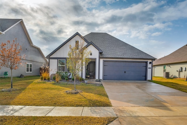 view of front facade with a garage, a front lawn, and cooling unit