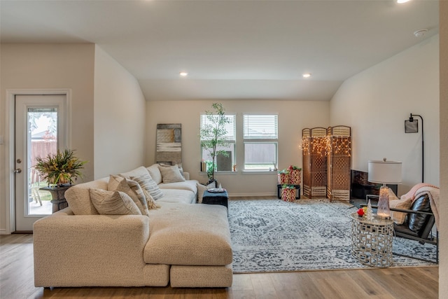 living room featuring light hardwood / wood-style floors and lofted ceiling