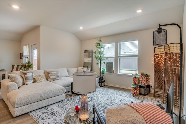 living room with wood-type flooring and vaulted ceiling