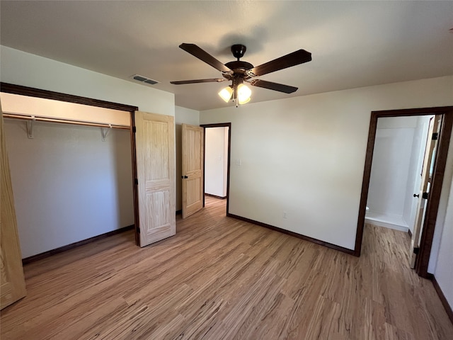 unfurnished bedroom with ceiling fan, a closet, and wood-type flooring