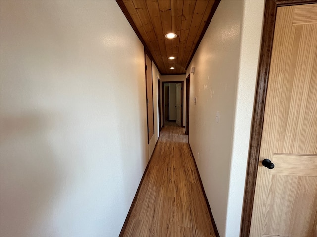 hall featuring wooden ceiling and hardwood / wood-style flooring