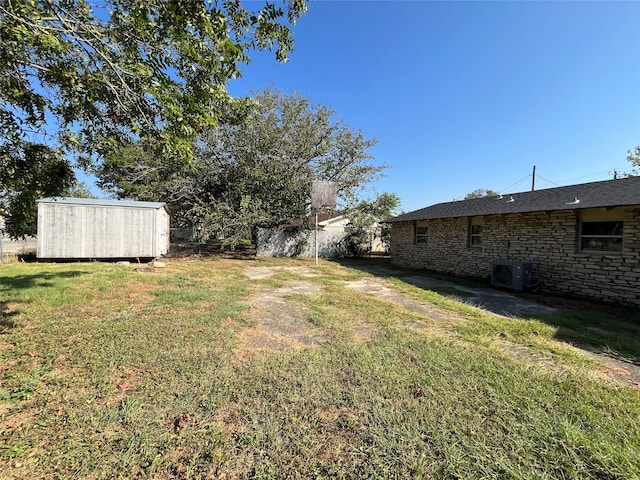 view of yard with a storage shed and central air condition unit