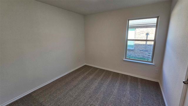 empty room with dark carpet