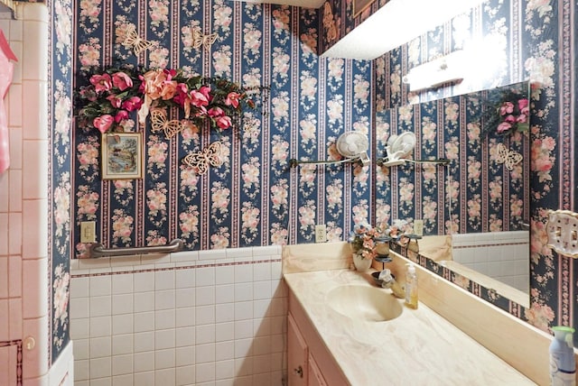 bathroom with vanity and tile walls