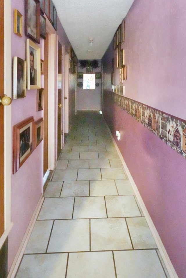 hall featuring light tile patterned flooring