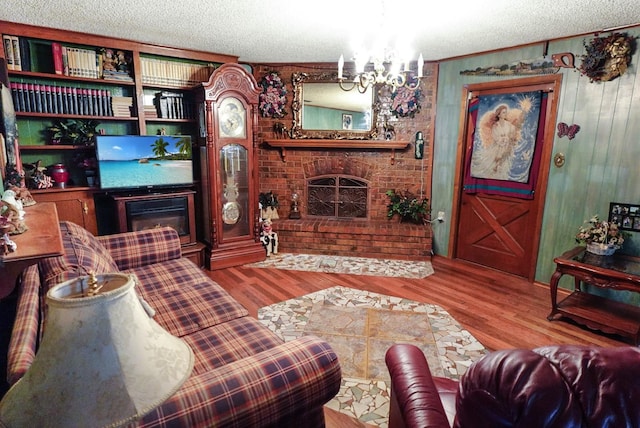 living room with a fireplace, hardwood / wood-style floors, and a textured ceiling