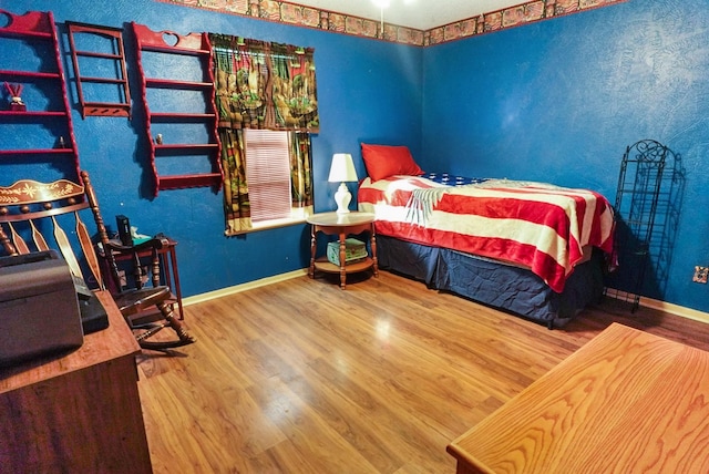 bedroom with hardwood / wood-style flooring