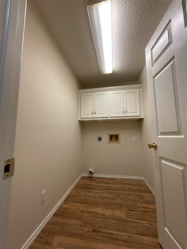 laundry room featuring wood-type flooring, electric dryer hookup, washer hookup, and cabinets