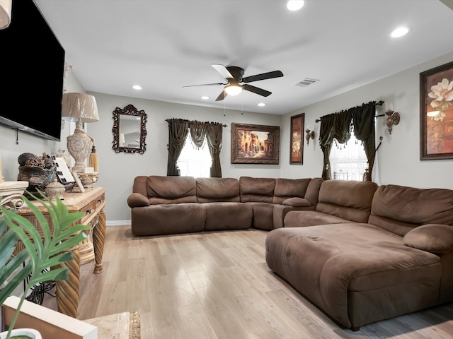 living room featuring ceiling fan and light hardwood / wood-style flooring