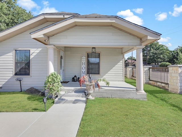 bungalow featuring a front lawn and covered porch