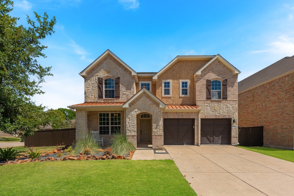 view of front of home featuring a garage and a front lawn