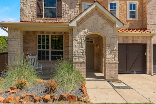 doorway to property with a garage