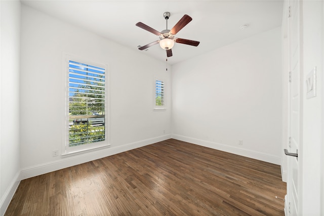 empty room with ceiling fan and dark hardwood / wood-style floors