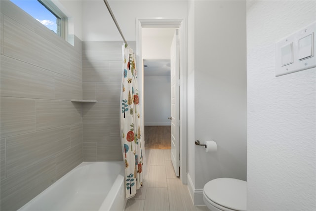 bathroom with tile patterned flooring, toilet, and shower / tub combo with curtain