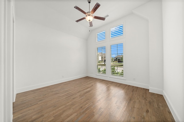 empty room with dark hardwood / wood-style flooring, ceiling fan, and lofted ceiling