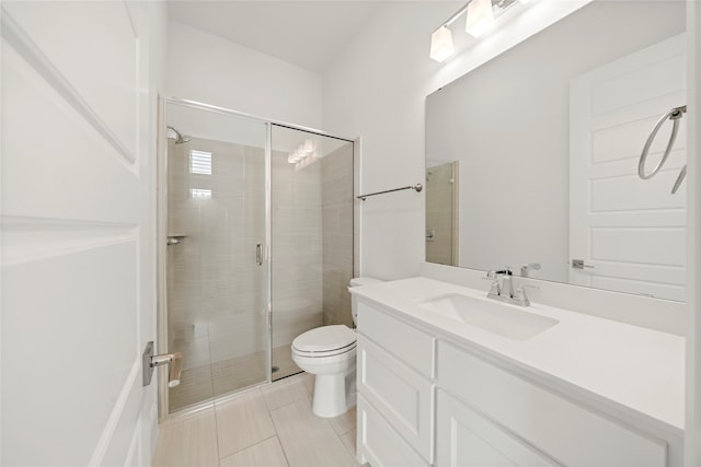 bathroom featuring vanity, toilet, tile patterned flooring, and walk in shower