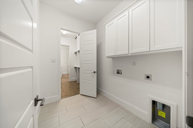 clothes washing area featuring cabinets, hookup for a washing machine, hookup for a gas dryer, and hookup for an electric dryer