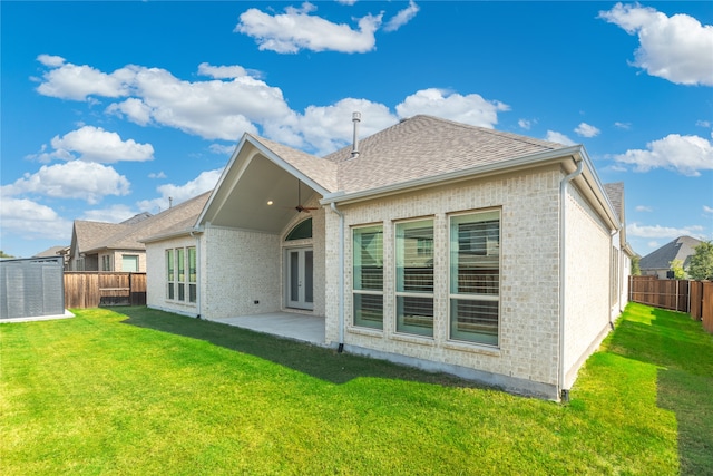 back of property featuring a patio area and a lawn