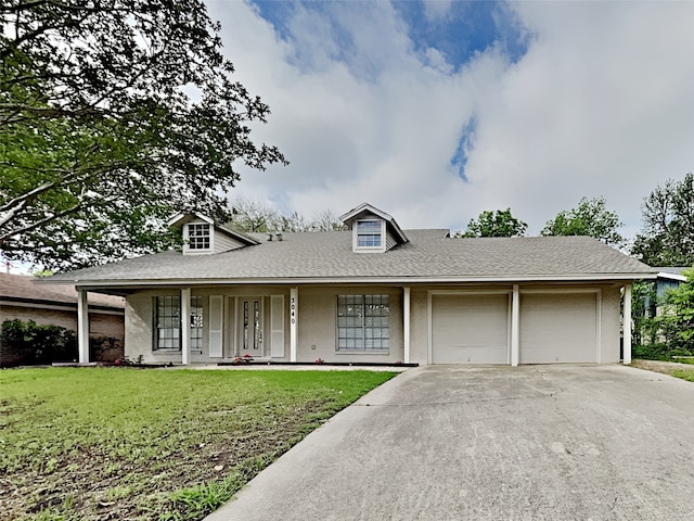 view of front facade with a front yard, a garage, and covered porch