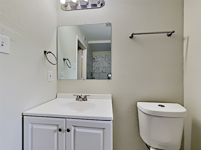 bathroom with toilet and vanity