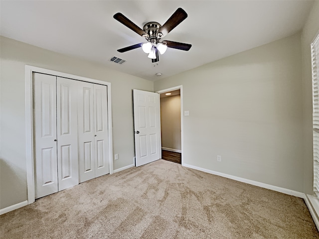 unfurnished bedroom featuring a closet, visible vents, baseboards, ceiling fan, and carpet floors