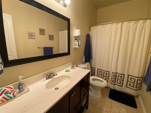 bathroom with tile patterned flooring, toilet, and vanity