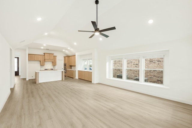 unfurnished living room with lofted ceiling, light hardwood / wood-style flooring, and ceiling fan