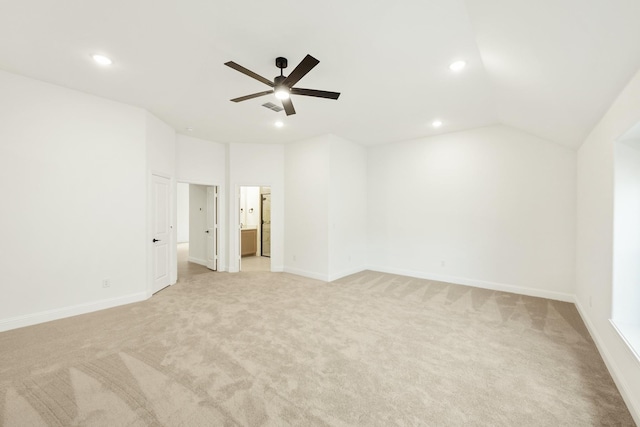 unfurnished room with ceiling fan, light colored carpet, and lofted ceiling