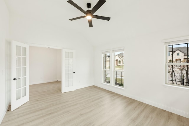 spare room featuring french doors, a healthy amount of sunlight, and light hardwood / wood-style flooring