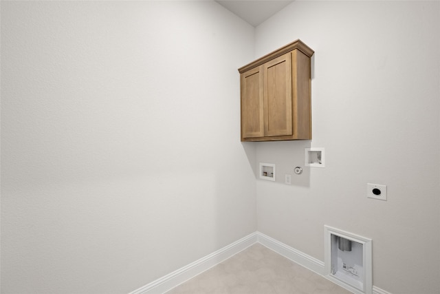 washroom featuring hookup for an electric dryer, washer hookup, cabinet space, baseboards, and gas dryer hookup