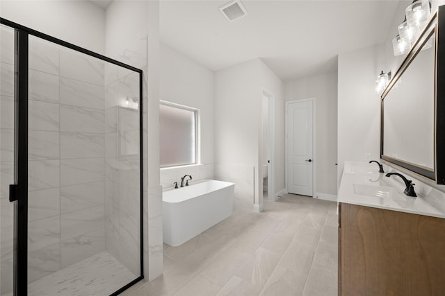 full bathroom featuring visible vents, toilet, a stall shower, a freestanding tub, and a sink