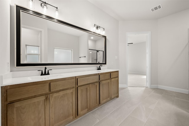 bathroom with a sink, visible vents, an enclosed shower, and double vanity