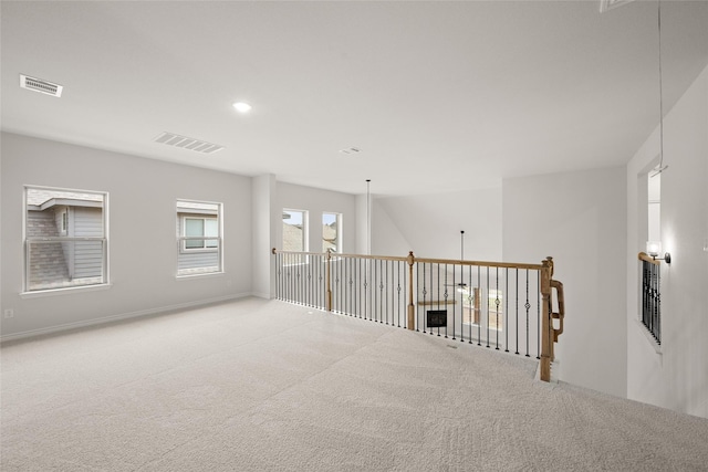 carpeted empty room featuring visible vents, recessed lighting, and baseboards